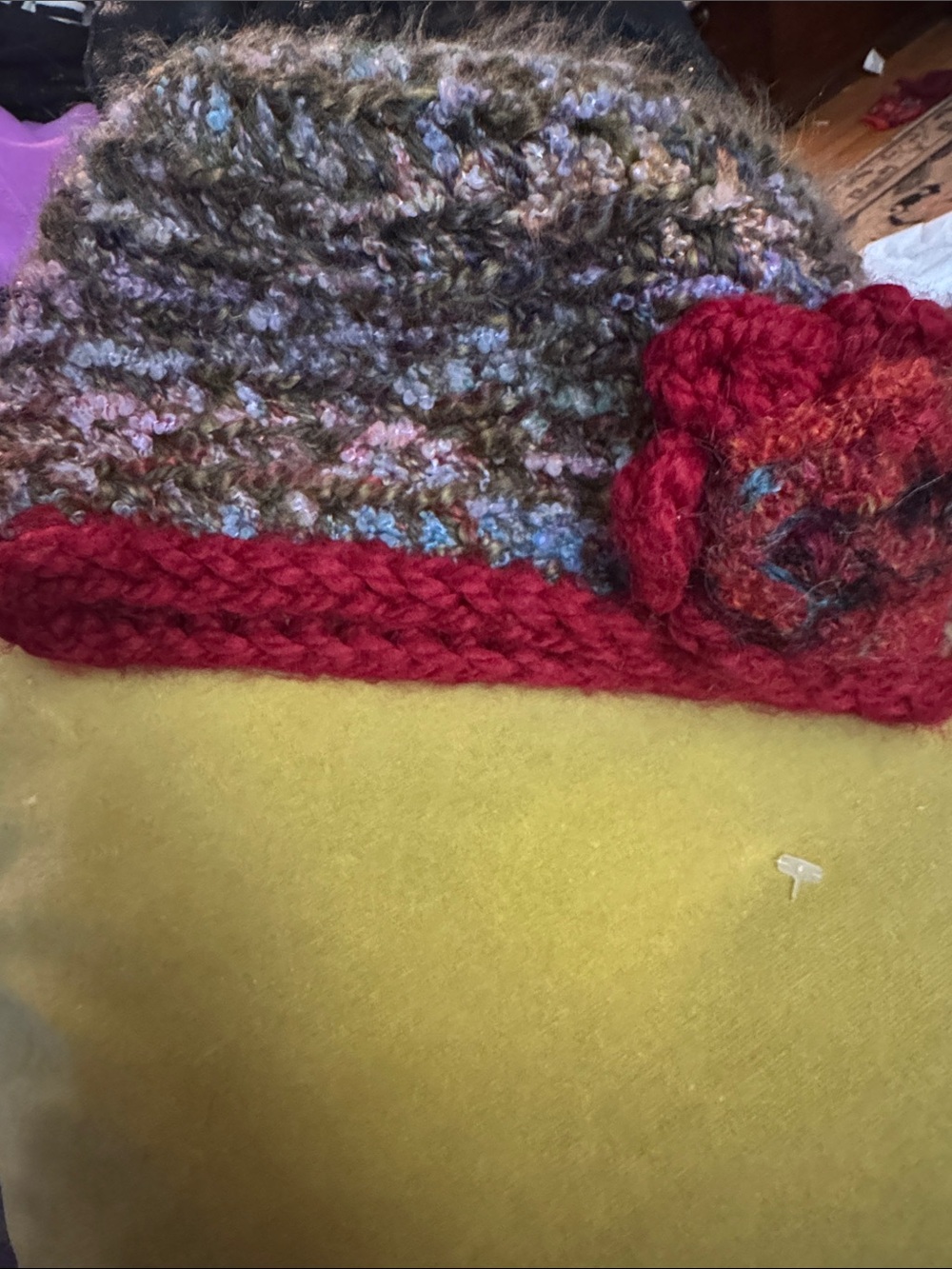 Hand Crafted Multicolor Knit Hat with Red Trim and Flower Accent